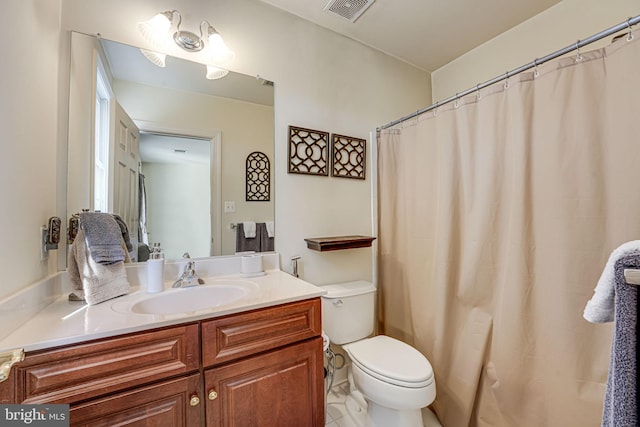 bathroom featuring tile patterned flooring, vanity, curtained shower, and toilet