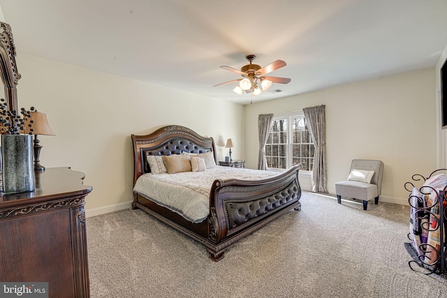 bedroom featuring ceiling fan and light carpet