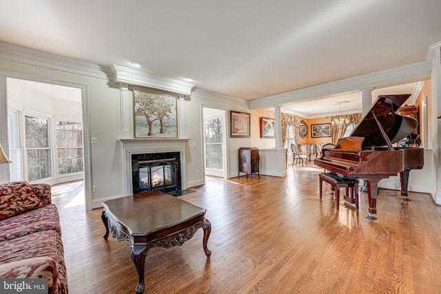 15280 Riding Club Dr, Haymarket, VA 20169 - living room with a high end fireplace, a chandelier, ornamental molding, wood finished floors, and baseboards