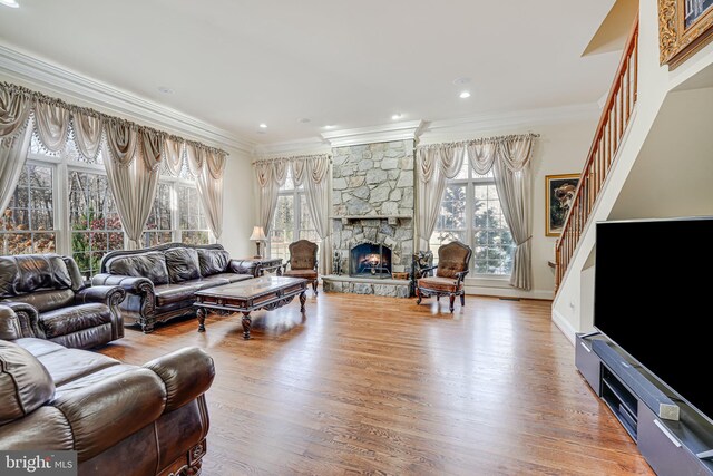 15280 Riding Club Dr, Haymarket, VA 20169 - living area with crown molding, a stone fireplace, wood finished floors, stairs, and baseboards
