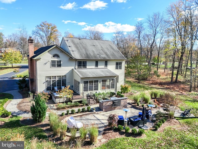 back of house featuring a deck