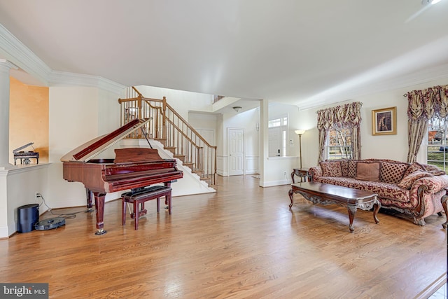 living room featuring hardwood / wood-style floors and ornamental molding