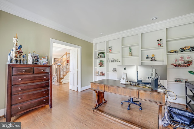 office area featuring light wood-type flooring, built in features, and ornamental molding