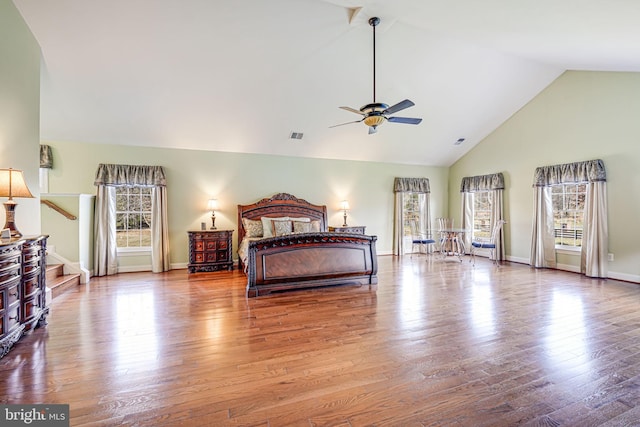 bedroom featuring high vaulted ceiling and hardwood / wood-style flooring