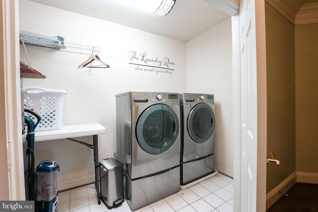 washroom featuring light tile patterned flooring and washing machine and clothes dryer