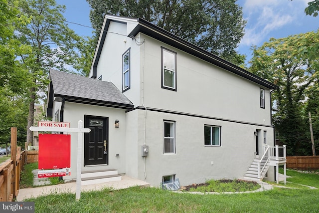 back of house featuring a lawn