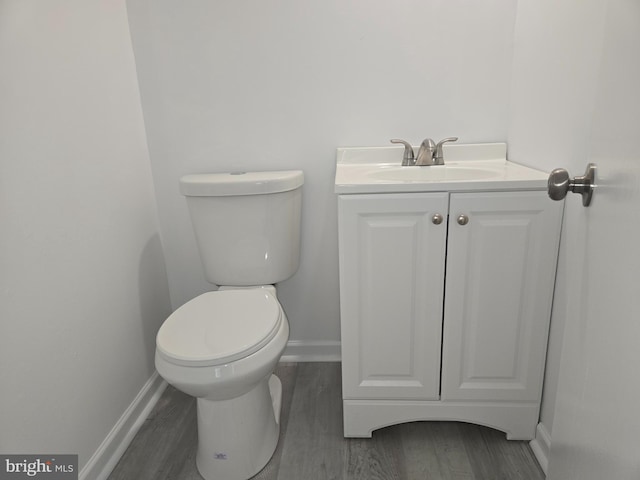 bathroom featuring hardwood / wood-style floors, vanity, and toilet