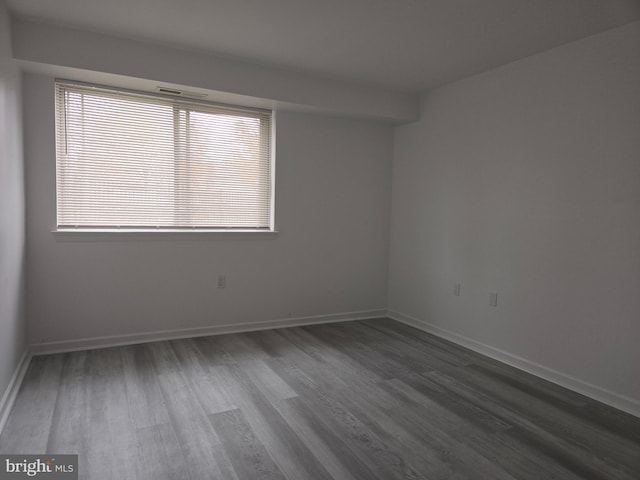 unfurnished room with hardwood / wood-style floors