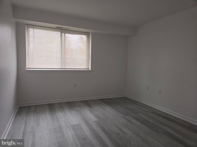 unfurnished room with hardwood / wood-style flooring