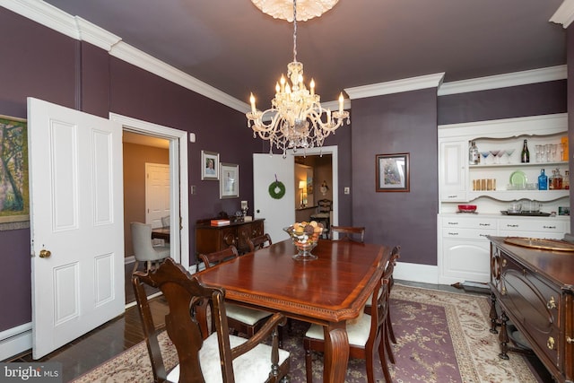 dining room with ornamental molding, dark wood-type flooring, baseboard heating, and an inviting chandelier