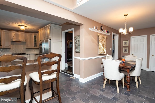 dining area with an inviting chandelier