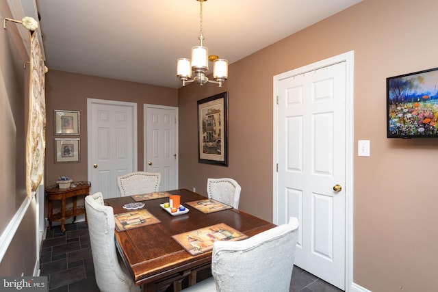 dining area featuring a notable chandelier