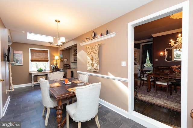 dining space with a healthy amount of sunlight and an inviting chandelier