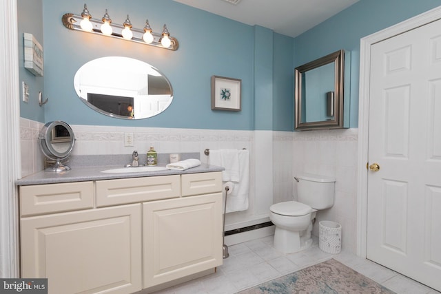 bathroom featuring tile patterned flooring, vanity, tile walls, and toilet