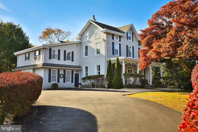 view of property featuring covered porch