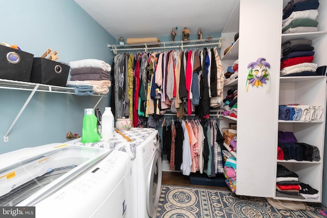 spacious closet featuring dark hardwood / wood-style flooring and washer and clothes dryer