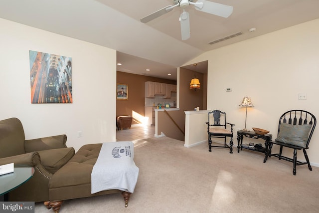 living room featuring light colored carpet, ceiling fan, and lofted ceiling