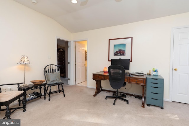 carpeted home office with vaulted ceiling