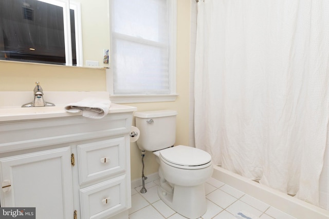 bathroom featuring toilet, a shower with curtain, vanity, and tile patterned floors