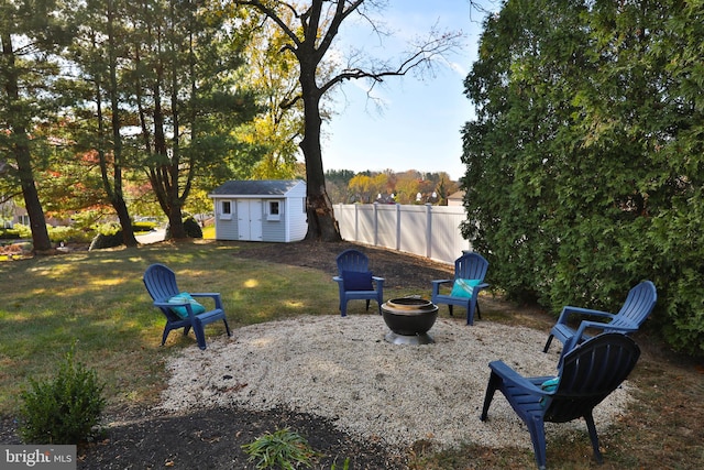 view of yard with an outdoor fire pit and a storage unit