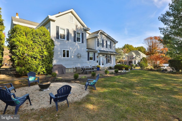 back of property featuring a lawn and a patio area