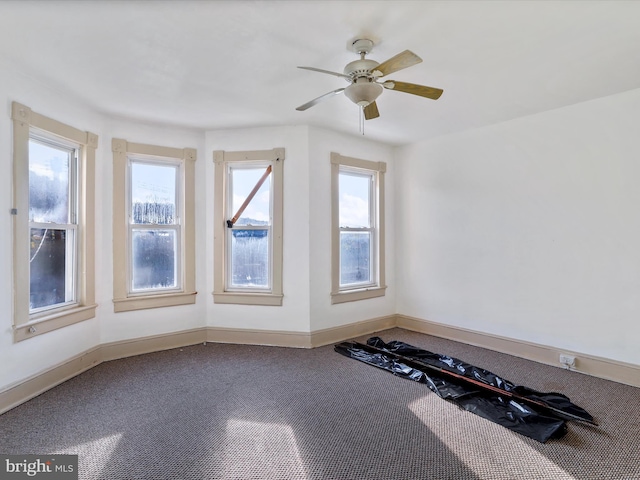 interior space featuring ceiling fan and carpet