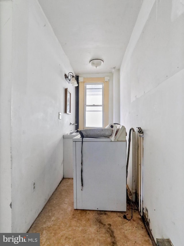 clothes washing area featuring washer / dryer