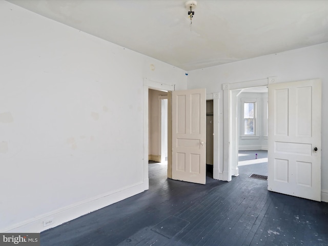 unfurnished bedroom featuring dark hardwood / wood-style flooring