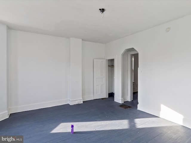 spare room with dark wood-type flooring