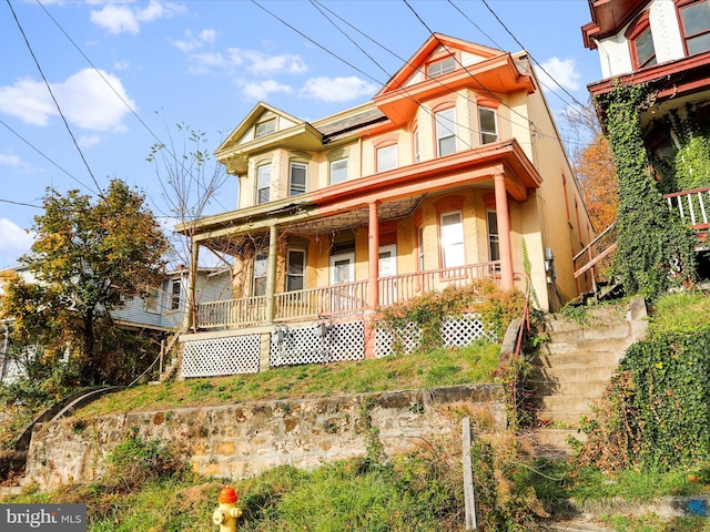 victorian-style house featuring covered porch