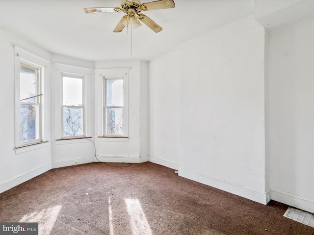 carpeted spare room with ceiling fan