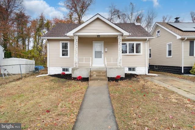 bungalow with a front lawn and a porch