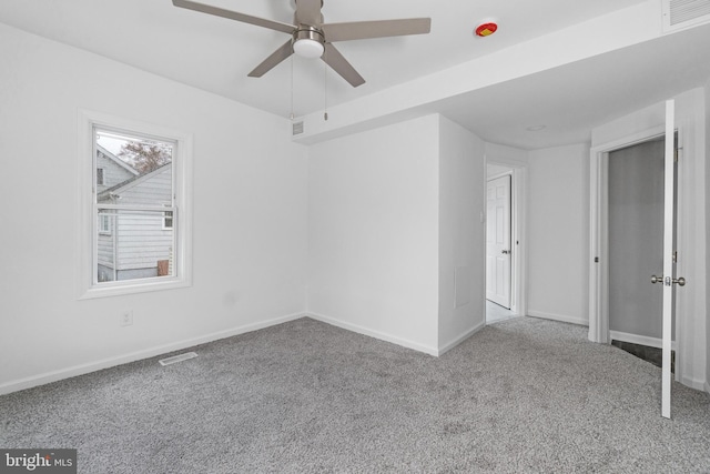 spare room with carpet and ceiling fan