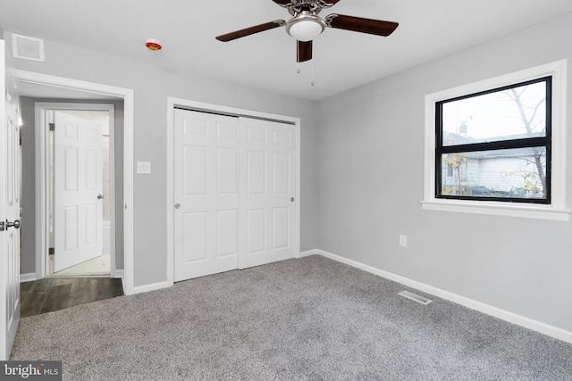 unfurnished bedroom with ceiling fan, carpet floors, and a closet