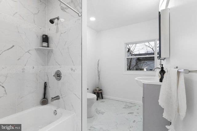 full bathroom featuring tiled shower / bath, vanity, and toilet