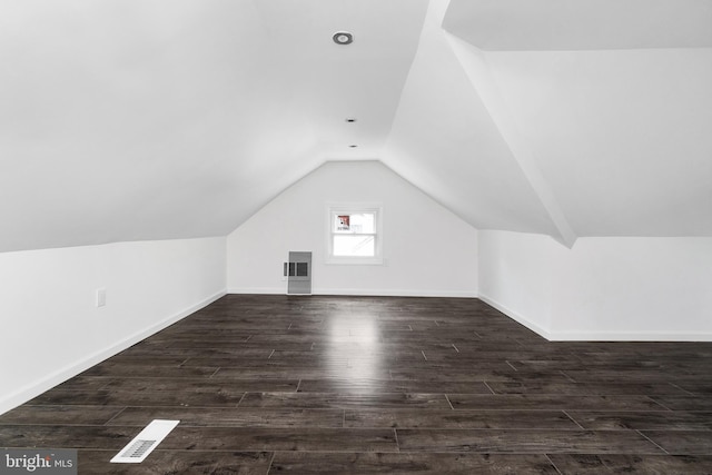 additional living space with lofted ceiling and dark wood-type flooring