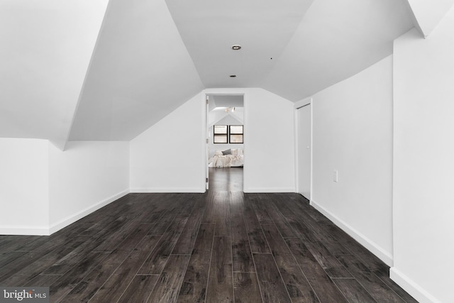 bonus room featuring lofted ceiling and dark wood-type flooring