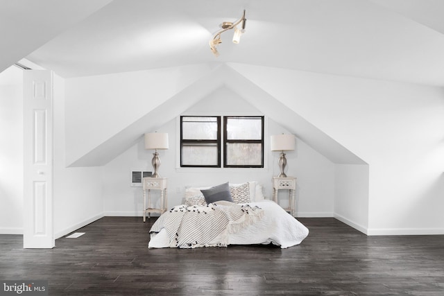 bedroom featuring dark wood-type flooring and lofted ceiling