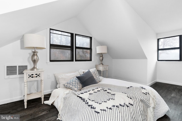 bedroom with dark hardwood / wood-style flooring and vaulted ceiling