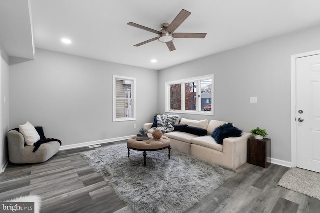 living room featuring hardwood / wood-style floors and ceiling fan