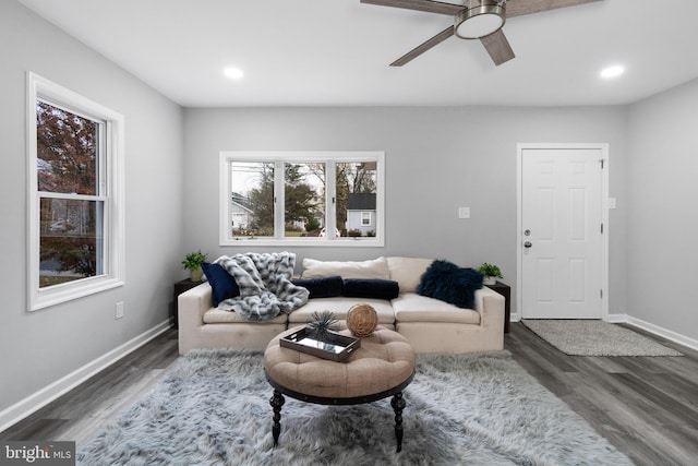 living room featuring dark hardwood / wood-style floors and ceiling fan