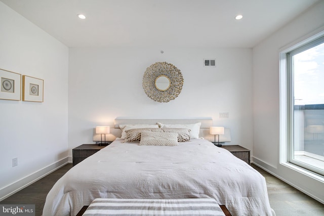 bedroom with dark wood-type flooring