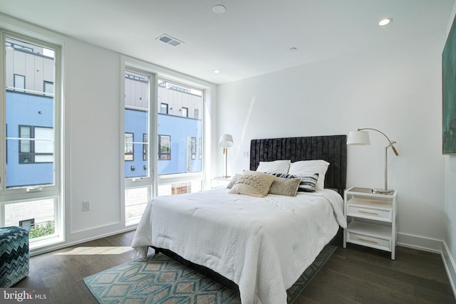 bedroom with dark hardwood / wood-style floors