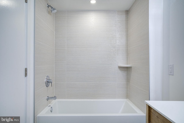 bathroom featuring vanity and tiled shower / bath combo