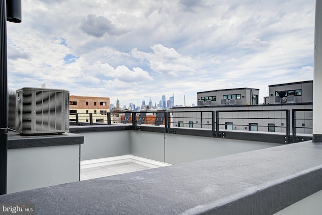 view of patio featuring a balcony and central AC