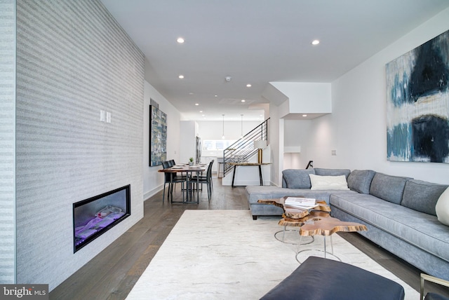 living room featuring a fireplace and dark wood-type flooring