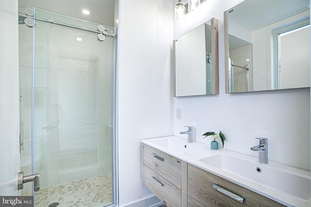 bathroom featuring vanity and an enclosed shower