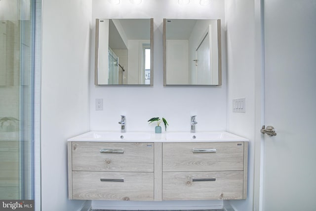 bathroom featuring vanity and a shower with door