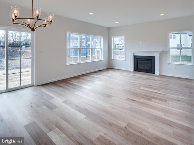 1 Tilghman Trl, Mechanicsburg, PA 17050 - unfurnished living room featuring a chandelier, light wood-style flooring, healthy amount of natural light, and recessed lighting