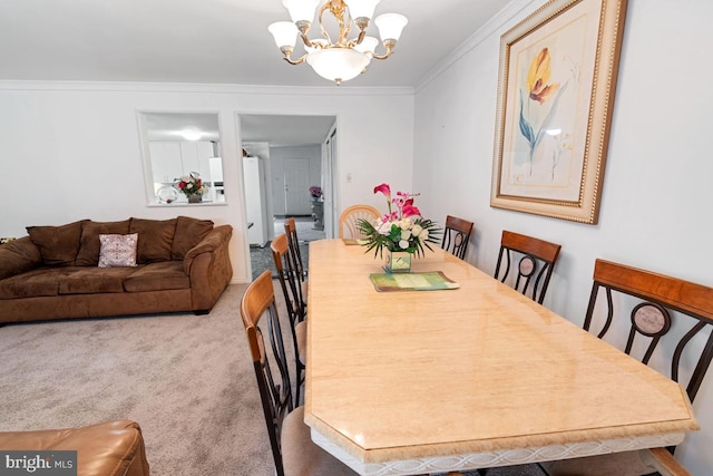 dining room featuring carpet, an inviting chandelier, and crown molding